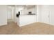 Bright living area boasts neutral colors and tile flooring flowing into the kitchen at 3041 Gary Cooper St # 103, Las Vegas, NV 89122