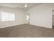 Neutral main bedroom features carpet, a ceiling fan, large window, and ensuite bathroom at 3041 Gary Cooper St # 103, Las Vegas, NV 89122