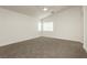 Vaulted ceiling in this main bedroom featuring neutral carpet, ensuite bathroom, and large windows at 3041 Gary Cooper St # 103, Las Vegas, NV 89122