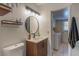 Modern bathroom featuring a wood cabinet, vessel sink and a laundry room nearby at 3061 Brockington Dr, Las Vegas, NV 89120