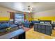 Spacious bedroom featuring bright yellow accent wall, hardwood floors, two beds, and modern furniture at 3061 Brockington Dr, Las Vegas, NV 89120