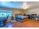 Bright bedroom featuring a large window and a comfortable bed with hardwood floors at 3061 Brockington Dr, Las Vegas, NV 89120