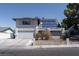 Charming two-story home with stucco exterior, solar panels, and desert landscaping at 3061 Brockington Dr, Las Vegas, NV 89120