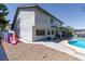 Two-story home with a backyard pool, covered patio, and play set with a slide at 3061 Brockington Dr, Las Vegas, NV 89120