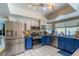 Bright kitchen with stainless steel appliances and blue cabinetry at 3061 Brockington Dr, Las Vegas, NV 89120