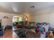 Spacious living room featuring hardwood floors, a large sofa, and natural lighting at 3061 Brockington Dr, Las Vegas, NV 89120
