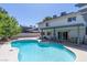 Backyard pool with a spa and patio is surrounded by lush landscaping and a two story home at 3061 Brockington Dr, Las Vegas, NV 89120