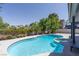 Sparkling backyard pool with an attached spa and lush landscaping, surrounded by trees at 3061 Brockington Dr, Las Vegas, NV 89120