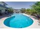 Backyard pool and spa surrounded by lush landscaping, a covered patio, and seating area at 3061 Brockington Dr, Las Vegas, NV 89120