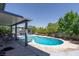 Backyard pool featuring a covered patio with seating, a spa, and mature landscaping at 3061 Brockington Dr, Las Vegas, NV 89120