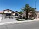 A single-story home featuring a gated entry, a three-car garage, and a meticulously maintained yard with palm trees at 3064 Azure Bay St, Las Vegas, NV 89117