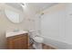 Bright bathroom featuring a shower-tub combo with white tile and modern fixtures at 317 E Van Wagenen St, Henderson, NV 89015