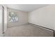 Bright bedroom featuring neutral carpet, a large window, and ample closet space at 317 E Van Wagenen St, Henderson, NV 89015