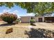 Exterior of building with rock landscaping, shaded trees, and well-maintained lawn at 317 E Van Wagenen St, Henderson, NV 89015