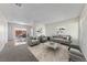 Bright living room with neutral walls, plush carpet, and contemporary furnishings, offering a comfortable and inviting space at 317 E Van Wagenen St, Henderson, NV 89015
