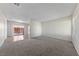 Spacious living room with neutral carpet, light walls, and sliding door to a patio at 317 E Van Wagenen St, Henderson, NV 89015