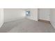 Bright living room features neutral carpet, baseboards, and a window for natural light at 317 E Van Wagenen St, Henderson, NV 89015