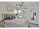Stylish bedroom with large windows, mirrored accents, and modern lighting fixtures at 3206 Fountaintree Ave, Henderson, NV 89044