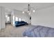 A well lit bedroom features plush seating, modern lighting fixtures, and an ensuite bath at 3206 Fountaintree Ave, Henderson, NV 89044