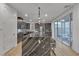 Modern kitchen with island, stainless steel appliances, custom cabinets, and sliding glass doors at 3206 Fountaintree Ave, Henderson, NV 89044