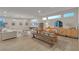 Bright living room with modern chandelier, stylish furniture, and light wood-look flooring at 3206 Fountaintree Ave, Henderson, NV 89044