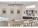 Living room featuring modern lighting fixture, comfortable sofa and lounge chairs at 3206 Fountaintree Ave, Henderson, NV 89044