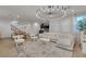 Bright, open floorplan with living area, stairs, and kitchen with island seating at 3206 Fountaintree Ave, Henderson, NV 89044