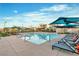 Community pool featuring lounge chairs and shaded areas for relaxation, surrounded by modern residential buildings at 3206 Fountaintree Ave, Henderson, NV 89044