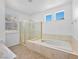 Bathroom featuring a tub, shower, and window, offering a spa-like experience at 3431 Cottage Thistle Dr, Laughlin, NV 89029