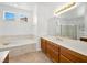 Bathroom showcasing a large vanity, tub, and shower, creating a luxurious space at 3431 Cottage Thistle Dr, Laughlin, NV 89029