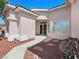 Inviting front entrance with a walkway and xeriscaping creating a low-maintenance and attractive approach to the home at 3431 Cottage Thistle Dr, Laughlin, NV 89029