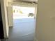 Garage featuring gray epoxy floors, white walls, and an overhead door at 3431 Cottage Thistle Dr, Laughlin, NV 89029