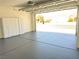Garage with gray epoxy floors, overhead door, and storage cabinets at 3431 Cottage Thistle Dr, Laughlin, NV 89029