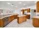 Spacious kitchen with wood cabinets, an island, stainless steel dishwasher and ample counter space at 3431 Cottage Thistle Dr, Laughlin, NV 89029