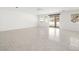 Spacious living room with tile floors, ceiling fan, and access to the backyard through sliding glass doors at 3431 Cottage Thistle Dr, Laughlin, NV 89029