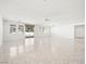 Open living space with neutral tile, lots of natural light, ceiling fan, and convenient backyard access at 3431 Cottage Thistle Dr, Laughlin, NV 89029