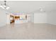 Bright and airy living space with tile floors, a ceiling fan, and seamless integration with an open kitchen at 3431 Cottage Thistle Dr, Laughlin, NV 89029