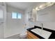 Bright bathroom featuring a vanity, toilet, bathtub and window with natural light and modern fixtures at 3630 N Pecos Rd, Las Vegas, NV 89115