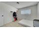 Minimalist bedroom with tile flooring, large window and a closet for organized storage solutions at 3630 N Pecos Rd, Las Vegas, NV 89115