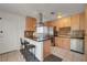 Updated kitchen featuring stainless steel appliances, tiled backsplash, and a breakfast bar with seating at 3630 N Pecos Rd, Las Vegas, NV 89115