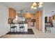 Modern kitchen featuring stainless steel appliances, wooden cabinetry, and a stylish breakfast bar area at 3630 N Pecos Rd, Las Vegas, NV 89115
