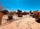 This is a fenced backyard with a playset on sand at 378 W Thomas Ave, Overton, NV 89040