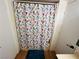 This is a full bathroom with a floral shower curtain and neutral walls at 378 W Thomas Ave, Overton, NV 89040