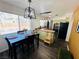 Bright dining area featuring a black table, pendant lighting, and a view of the kitchen at 378 W Thomas Ave, Overton, NV 89040