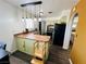 Well-lit kitchen with stainless steel appliances, modern countertop, and a charming breakfast bar at 378 W Thomas Ave, Overton, NV 89040