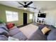 Spacious living room with modern ceiling fans, wood floors, and a comfortable couch at 378 W Thomas Ave, Overton, NV 89040