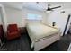 This is a bedroom with a large bed, an orange chair, and ceiling fan at 378 W Thomas Ave, Overton, NV 89040
