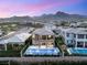 Stunning aerial view of a home with a backyard pool and mountains, showcasing the community and desert landscape at 390 Coastal Redwood St, Las Vegas, NV 89138