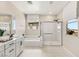 Bright bathroom features a double sink vanity, separate shower and tub, and plenty of natural light from large windows at 390 Coastal Redwood St, Las Vegas, NV 89138