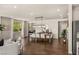 A dining room features a hardwood floor, an eight-seater wooden table, and modern pendant lighting at 390 Coastal Redwood St, Las Vegas, NV 89138